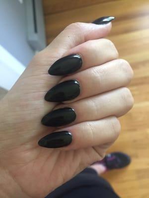 Black nail polish, full set of acrylic stiletto nails.