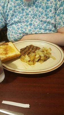 A small, less expensive steak sandwich is plenty of red meat, cooked right; w Texas toast and a potato. We asked for onion, too.