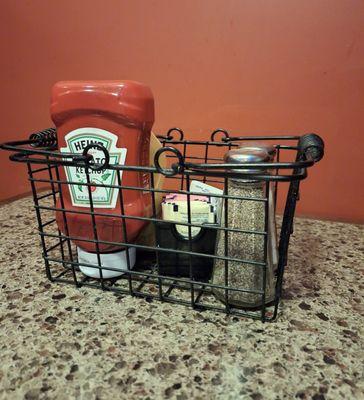 Condiment holder on table.