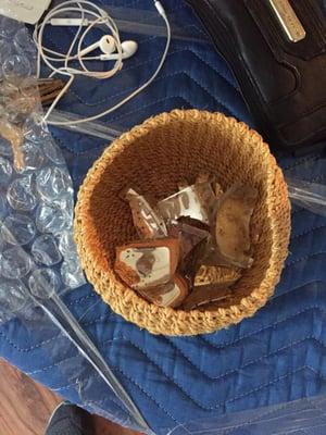 Shattered candle that had been bubble wrapped, inside a wicker basket and covered with clothes