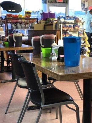 Sweet tea pitchers are placed on tables for refills