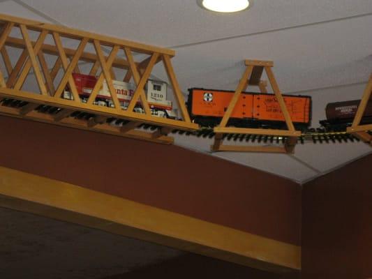 Model train runs along the ceiling