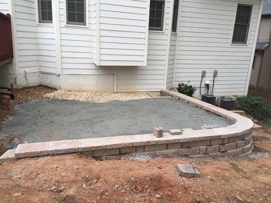 Progress  pic of raise Belgard paver patio with retaining wall, stone stairs, walkway pavers, and zoysia sod in Buford ga.