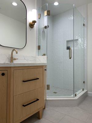 New guest bath - brushed brass hardware for the glass shower door