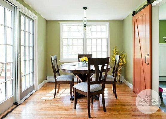 JM Construction created this small dining area with a sliding barn door.