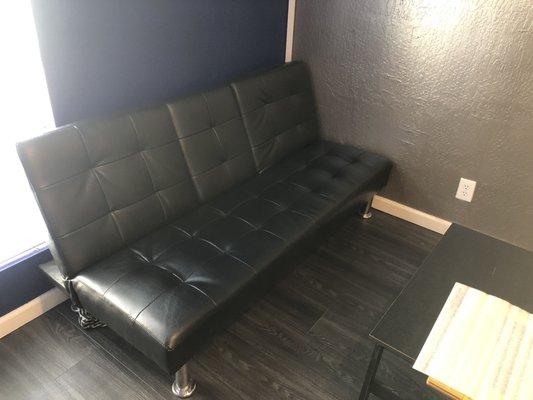 Couch where you can sit and wait while your phone gets fixed.