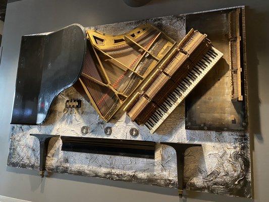 Wall Art of a deconstructed piano. The decorations here are so fun!