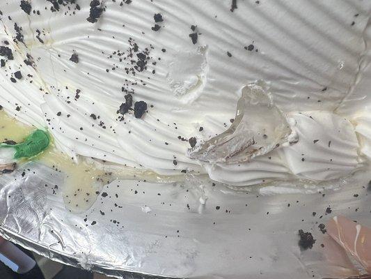 You can see big piece of broken glass and tiny pieces in the side of cake.