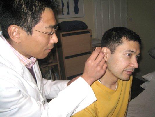 Dr. Simon Xue treating his patient