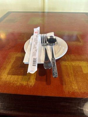 Chop sticks, fork, spoon, napkin and plate.