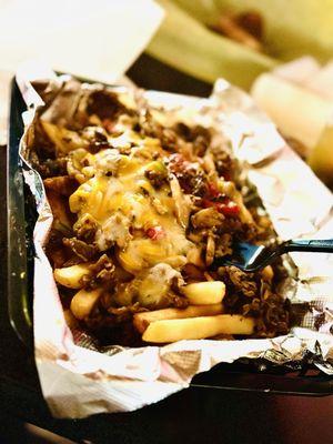 Shaved steak, cheese, mushrooms, onions and peppers over a bed of fries