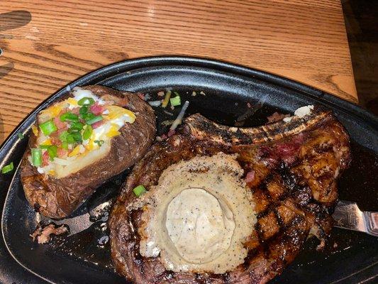 Ribeye steak bone in and a Loaded Baked Potato