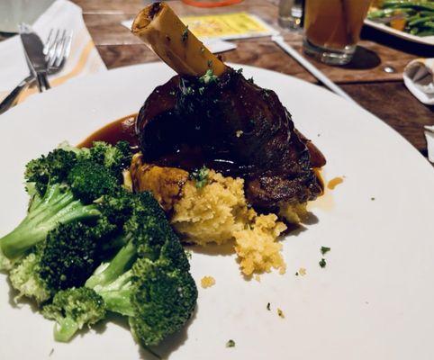 Lamb shank,  Y green beans in the background with the apple cider cranberry drink.