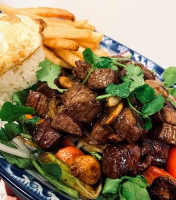 Mekong Special - Shaken Beef - marinated cubed beef sauteed, over greens, w jasmine rice, fried egg and fries