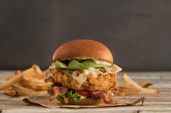 All natural hand-breaded chicken sandwich with bacon, Swiss cheese, avocado, lettuce, tomato, and ranch