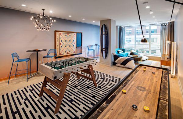 Hoyt & Horn Brooklyn | Gameroom with pinball machine, shuffle board, foosball and board games