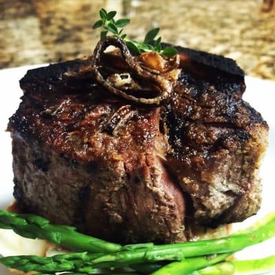 12 OZ bone in rib eye with parma cream potatoes, blanched asparagus, finished with herbed butter & fried shallots. The BOMB!