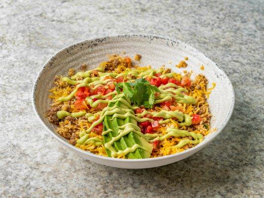 Taco Bowl with caulirice, Chili Campana salsa, grass-fed beef, cheddar cheese, avocado slices - topped with Avocado Crema