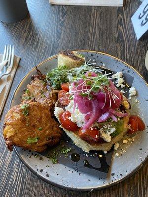 Avocado toast on homemade english muffin with a side of potato cakes