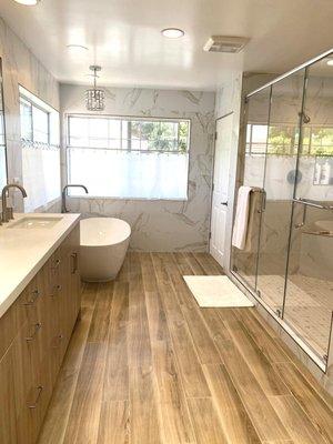 tile floor look like a wood , tub and shower.