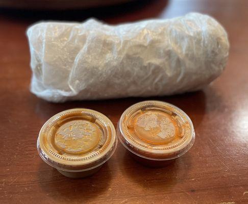 Breakfast Burrito wrapped nicely in paper and plastic wrap.  Mild and spicy salsas.