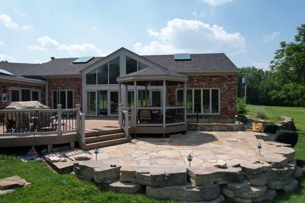 We crafted a rock patio, adorned the area with landscape lighting, and refreshed the deck and gazebo trim.