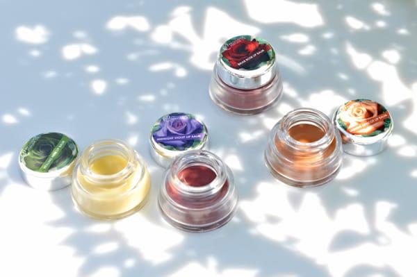 Our organic lip balms made with floral waxes in jasmine apricot, bramble berry rose, healing herb and midnight violet.