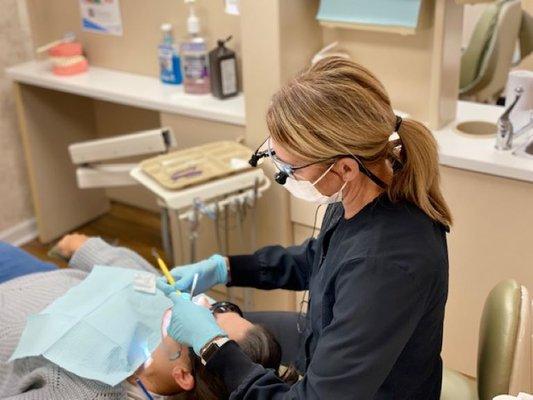 Tracy cleaning a patient's teeth