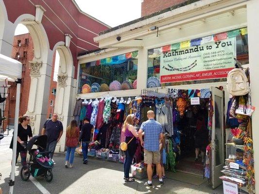 Right at end on Ankeny where you walk through columns to Skidmore Fountain, shop is loaded with ethnic clothes & accessories