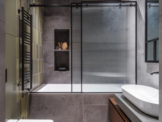 The bathroom is minimalistic and modern in style.