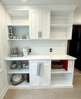 Pantry with crown and marble counter top.