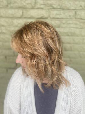 Strawberry blonde with highlights and shaggy layers