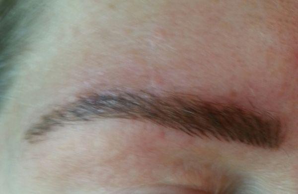 Brow hairstroke tattoo