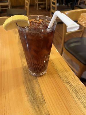 Iced tea with crinkle straw... but the tea has something in it... cinnamon maybe?