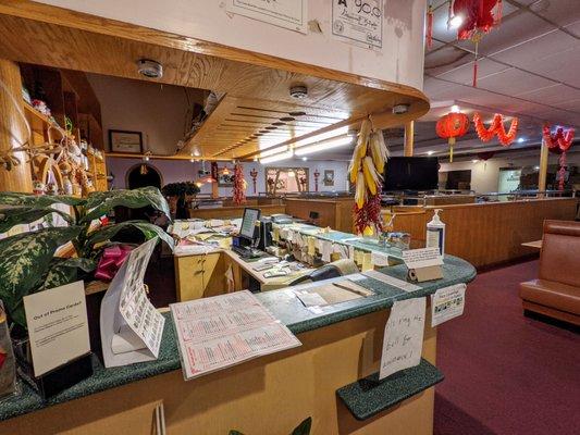 Inside. View of counter at entrance. Dining room to right.