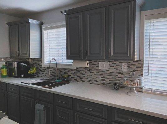 Elevate your kitchen game with a stunning backsplash and a chic raised bar peninsula!