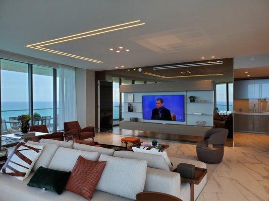 Living room home theater with wall mounted Samsung Frame TV with invisible in-ceiling speakers and full automation with wi-fi remote