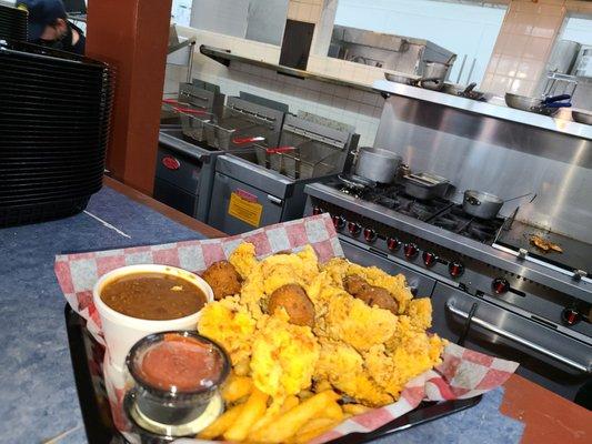 Seafood dinner  Shrimp, catfish, grouper with Cajun fries and side of red beans and rice .