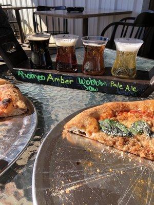 Beer flight and pizza on the patio