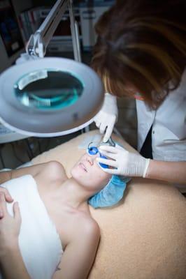 One of Ajune's aestheticians, Olga, performing a deep cleansing facial.