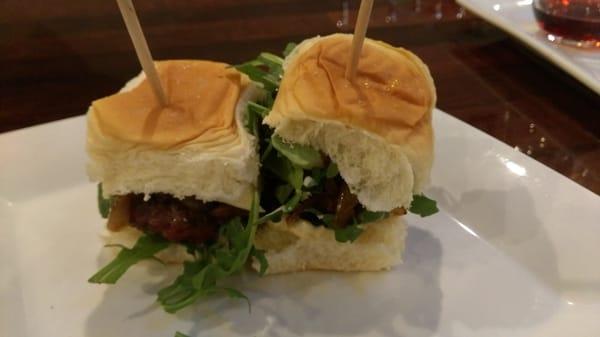 Salty Sally sliders made with ground beef, pork and bacon, topped with caramelized onion, blue cheese, dijon mayo and arugula.