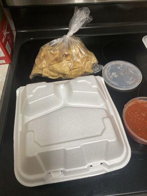 Upside down food container our tacos were in and the little bag of chips we paid for.