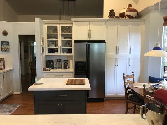 Refrigerator is now centered on wall with large pantry on RH side.