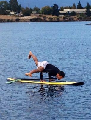 Fun arm balances on paddle board.