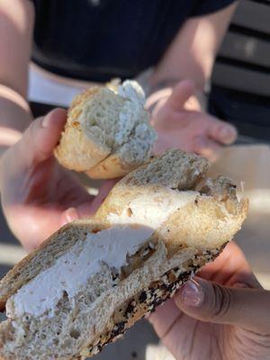 top: asiago bagel toasted w/ regular spread bottom: whole wheat everything bagel toasted w/ lox spread