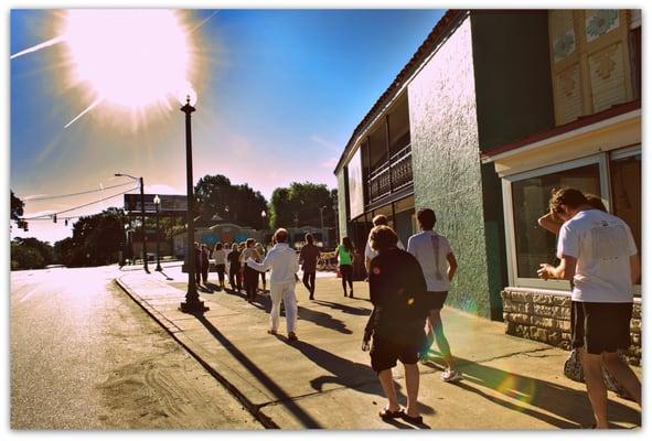 The long time sun shining upon us on our mantra walk around Overton Square.