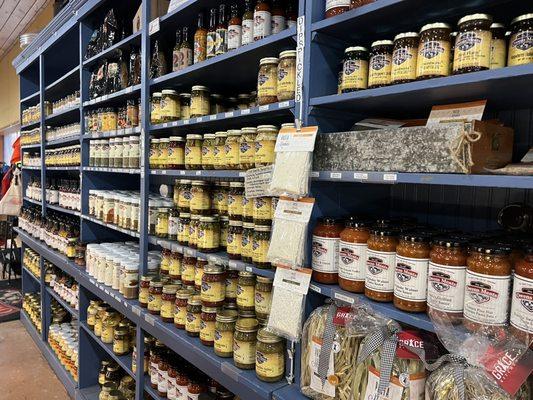 Just a portion of the long wall of related groceries of ingredients, sauces and dried goods