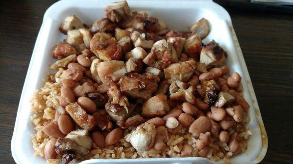 Large portion to go - Bourbon chicken and two chosen sides (spicy rice and beans)