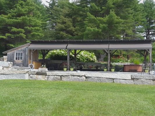 Awning along front of shade house by pool.