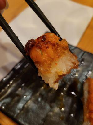 Close up of crispy rice topped with spicy salmon.